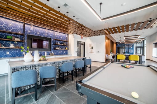 a game room with a pool table and chairs at The Century at Purdue Research Park-Student, West Lafayette Indiana