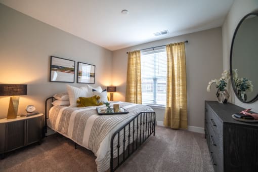 a bedroom with a bed and a dresser and a window at The Century at Purdue Research Park-Student, Indiana, 47906