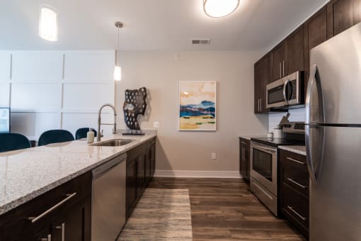 a kitchen with stainless steel appliances and a marble counter topat The Century at Purdue Research Park-Student, West Lafayette, IN 47906