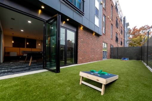 a yard with a table and a brick wall at 310 at Nulu Apartments-Student, Louisville, KY 40202