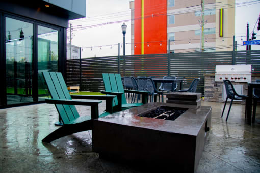 a patio with chairs and a fire pit at 310 at Nulu Apartments-Student, Kentucky