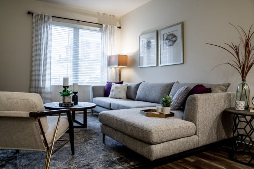 a living room with couches and chairs and a table at 310 at Nulu Apartments-Student, Kentucky, 40202