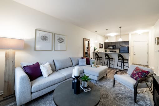 a living room with a couch and a table and a kitchen at 310 at Nulu Apartments-Student, Kentucky, 40202
