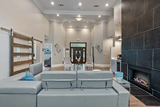 A modern living room with a grey sofa and a fireplace at Village at Almand Creek, Conyers, GA