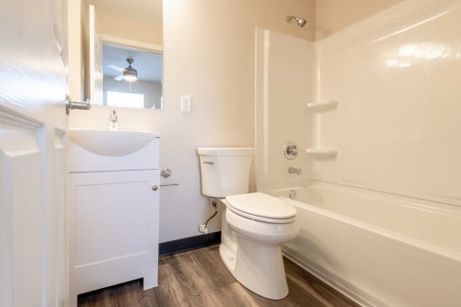 a bathroom with a toilet sink and bath tub