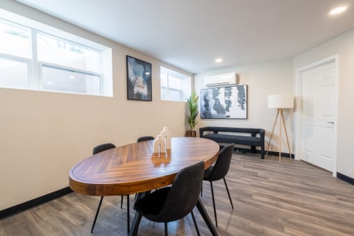 a dining room with a wooden table and chairs