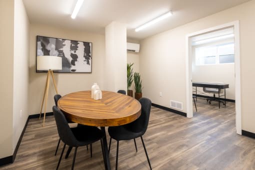 a dining room with a wooden table and chairs