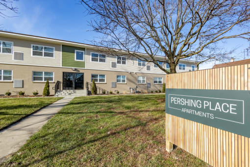 an apartment building with a parking place sign in front of it