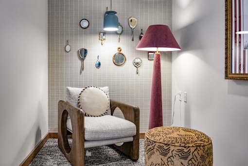 A quiet, enclosed private study or meeting room featuring a spacious desk, comfortable seating, and a warm wood-paneled accent wall, ideal for remote work or small collaboration sessions.
