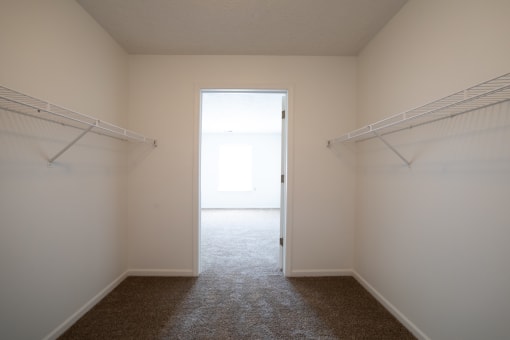 a walk in closet in a bedroom at the oxford at estonia apartments in san an