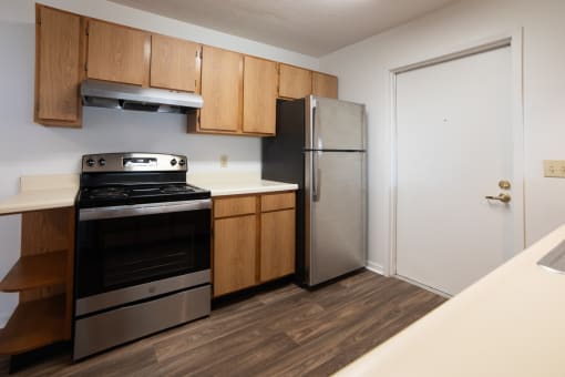 a kitchen with a stove and refrigerator in a 555 waverly unit