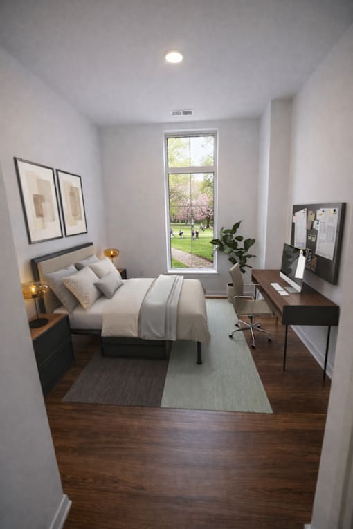 A bedroom with a bed, desk, and chair.