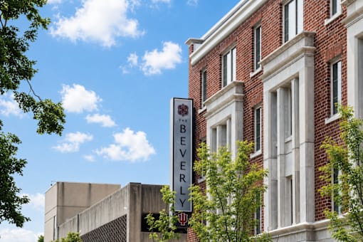A sign that says "Beverly" is hanging in front of a building.