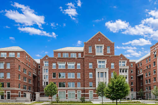 A large red brick building with multiple windows and doors.