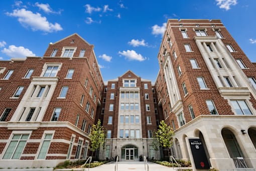 A large red brick building with a clear blue sky in the background.