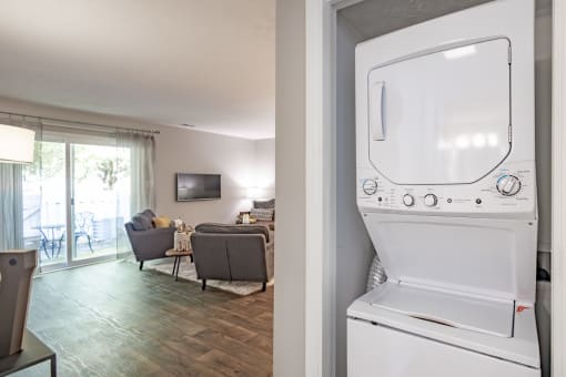 the living room has a washer and dryer in it and a living room