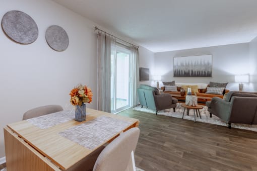 a living room and dining room with a table and chairs