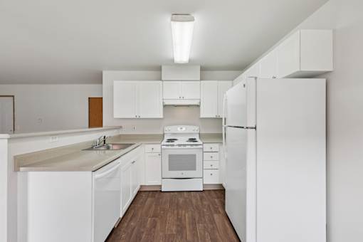 A kitchen with white cabinets and appliances  at The Timbers by Vintage, 98223