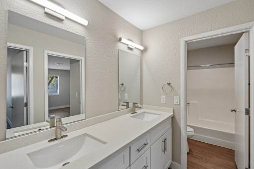 Modern bathroom with dual vanity sinks at Dash Apartments, Las Vegas, 89104