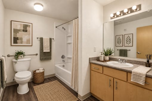 A bathroom with a white toilet, a white sink, and a white bathtub.
