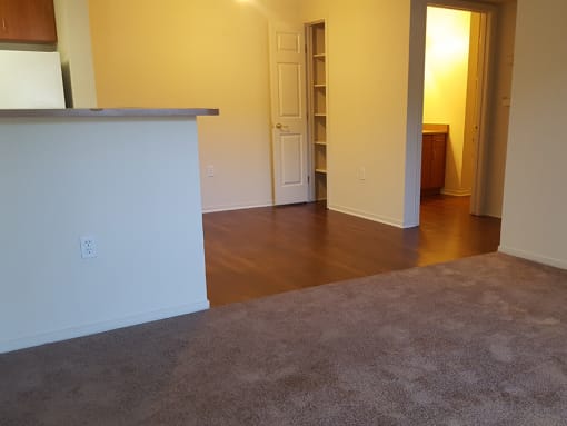 Living area with kitchen and pantry space at DOVER WOODS SENIOR APARTMENTS, Fairfield, CA 94533