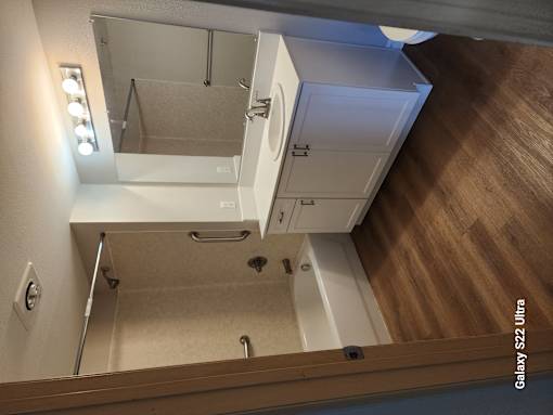 A bathroom with a shower and a toilet.