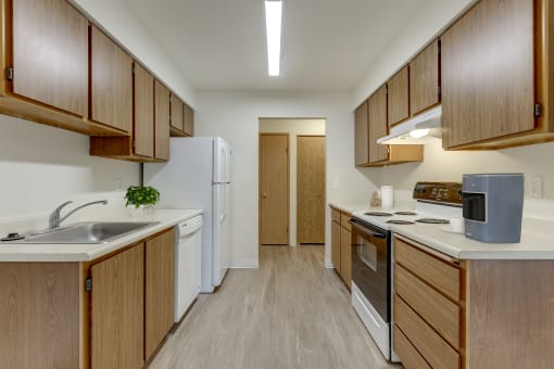 Apartments In Sherwood - Kitchen With Ample Cabinets, Full-Sized Appliances, Refrigerator, Stove, Dishwasher, And Plenty Of Counterspace.