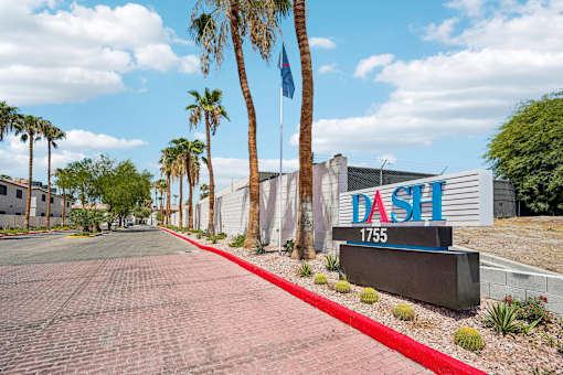 Property entrance sign with palm trees at Dash Apartments, Las Vegas, Nevada