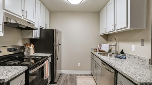 Pet Friendly apartments in Hayward CA - Austin Commons - upgraded kitchen with stainless steel appliances, white cabinetry, granite countertops