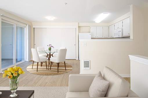 A living room with a white couch and a glass table with flowers on it at Troutdale Terrace, Troutdale, 97060