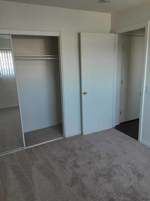 Bedroom with mirrored closet doors