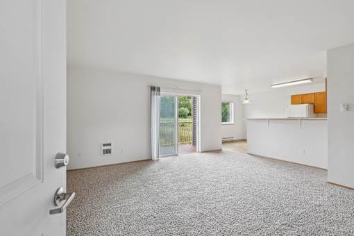 A white door is on the left of a room with a carpet  at The Timbers by Vintage, 98223