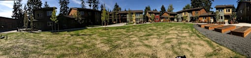 A grassy area in front of apartment buildings.at Bridge Meadows Beaverton 55+, Beaverton, OR 97005