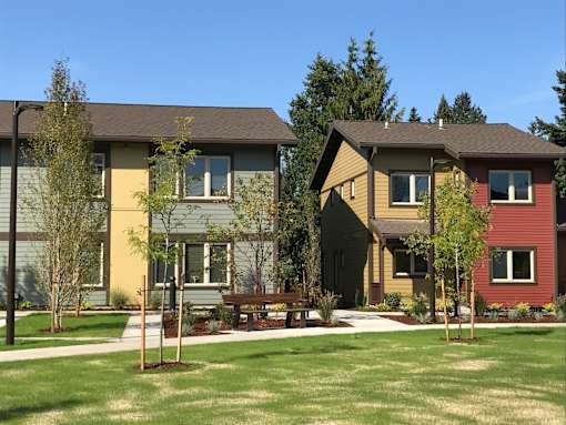 A row of houses with green lawns in front.at Bridge Meadows Beaverton 55+, Beaverton, OR