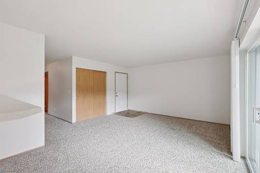 A room with a carpeted floor and white walls.