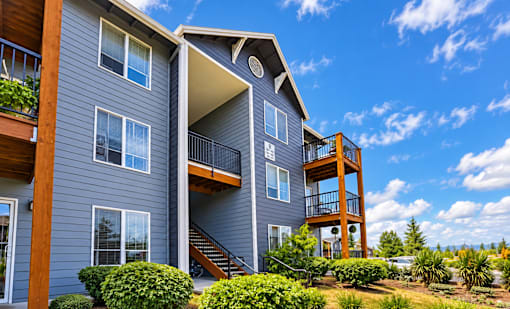 A modern two-story building with a balcony on the second floor.