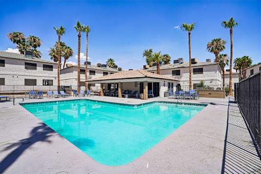 Sparkling swimming pool with cabana and lounge seating at Dash Apartments, Las Vegas, NV 89104