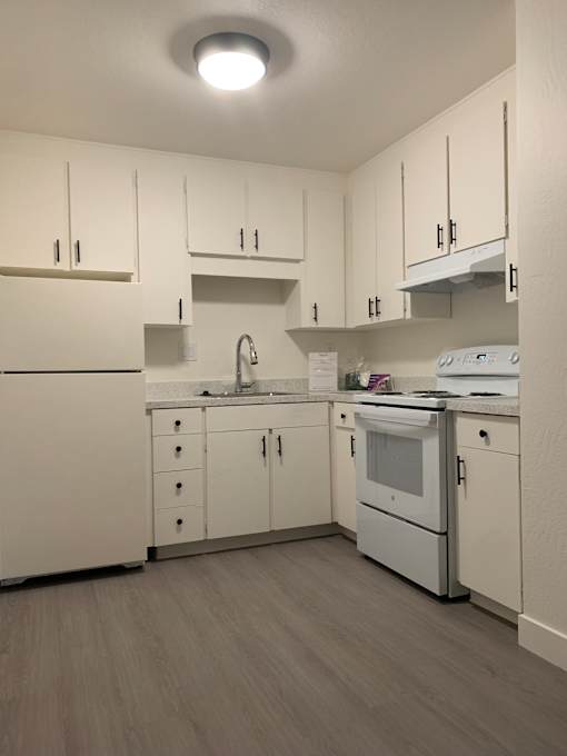 A white cabinet with a light on the wall at OTAVON APARTMENTS, CA 94947