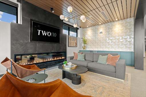 A living room with a fireplace and a grey couch at Two 10 by Vintage, Shoreline, 98133