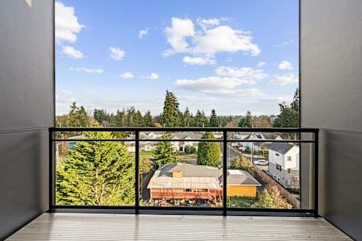 A balcony with a view of a residential area at Two 10 by Vintage, Washington 98133