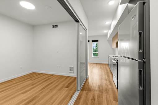 A kitchen with a refrigerator on the right side at Two 10 by Vintage, Shoreline