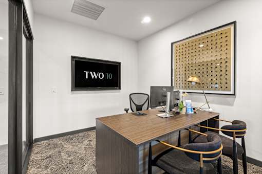 A room with a desk, chair, and a picture on the wall at Two 10 by Vintage, Washington