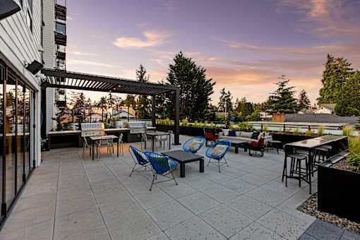 A patio with a table and chairs is set up outside  at Two 10 by Vintage, Shoreline, WA