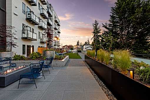 A patio with chairs and a fire pit in front of a building  at Two 10 by Vintage, WA, 98133