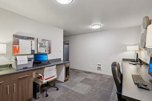 A modern office with a desk, chair, and computer.