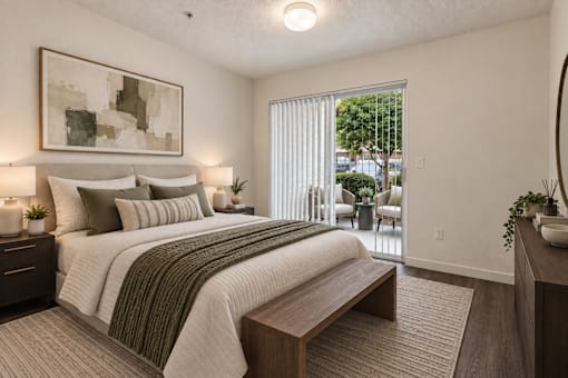 A bedroom with a large bed and a painting on the wall.