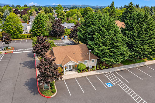 A parking lot with a building and a handicap parking spot.