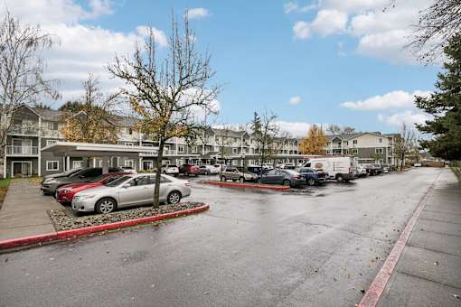 A parking lot with cars and apartment buildings in the background.at Vintage at Vancouver, Vancouver
