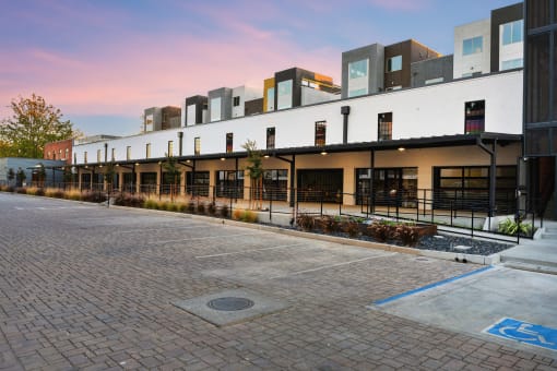 a row of buildings with balconies and a brick sidewalk