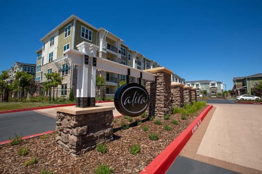 Entry to community with monument sign l Alira Apartments in Sacramento Ca